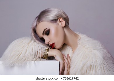 Beautiful Blond Young Woman In White Fur.winter Fashion.Beauty Sexy Model Girl With Bob Hair And Make-up