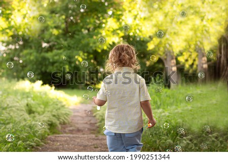 Similar – Adorable little girl playing with a ball sitting on a park bench