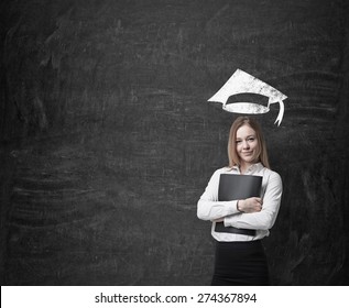 Beautiful blonde business woman is thinking about further business education. A concept of MBA programme. - Powered by Shutterstock