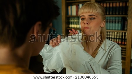Beautiful Blonde Caucasian Woman Feeling Extremely Upset and Ripping Apart Her Writer Boyfriend's Work. Young Female Destroying Her Husbands Written Chapters Out of Anger. 