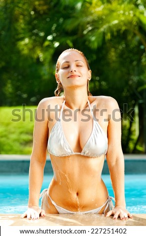 Beautiful blonde coming out of the swimming pool