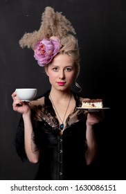 Beautiful blonde countess with cake and cup on dark background - Shutterstock ID 1630086151