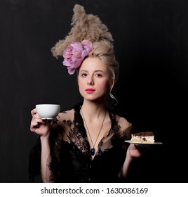 Beautiful blonde countess with cake and cup on dark background - Shutterstock ID 1630086169