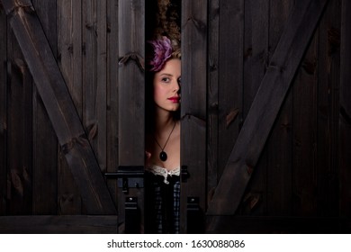 Beautiful blonde countess with vintage hairstyle and corset on dark background - Shutterstock ID 1630088086