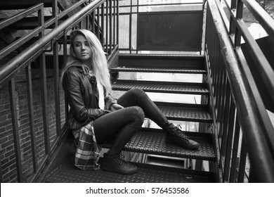 Beautiful Blonde Downtown Sitting On A Fire Escape - Black And White Photo