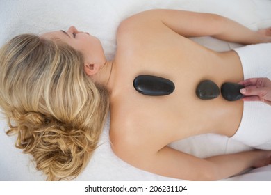 Beautiful Blonde Enjoying A Hot Stone Massage At The Health Spa