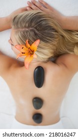 Beautiful Blonde Enjoying A Hot Stone Massage At The Health Spa