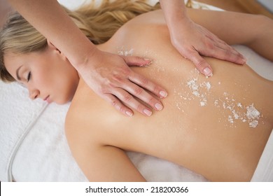 Beautiful Blonde Enjoying A Salt Scrub Treatment At The Health Spa