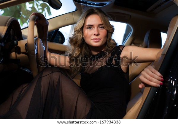 Beautiful blonde in an\
expensive car