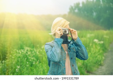 Beautiful Blonde Female Photojournalist Traveling And Taking Picture Outdoors In Sun Rays 