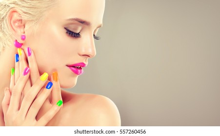 beautiful blonde girl with colorful manicure nails . Cosmetics,makeup and beauty