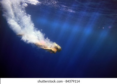 beautiful blonde girl dive underwater