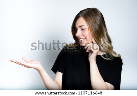 beautiful blonde girl presenting your product on the palm of your hand, isolated studio photo on the background