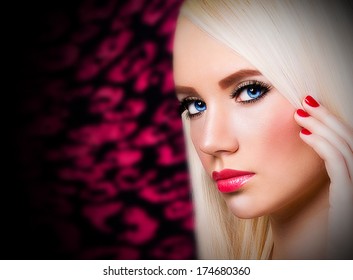 Beautiful blonde girl with red lips and nails