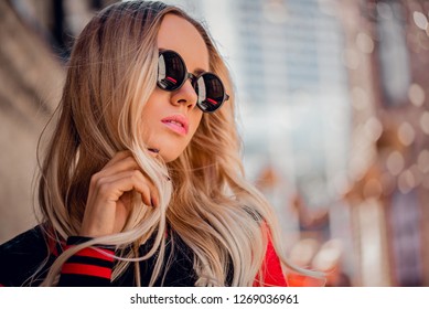 Beautiful blonde girl in sunglassses outdoor