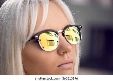 Beautiful blonde girl in sunglassses outdoors