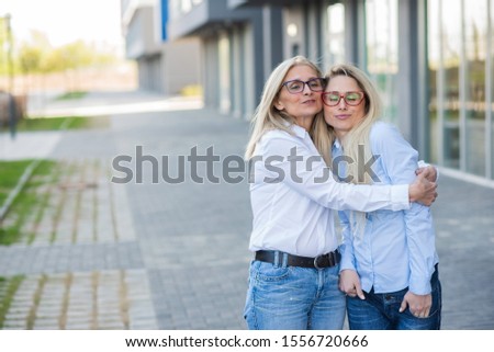 Similar – Image, Stock Photo Twin sisters look around in an alleyway