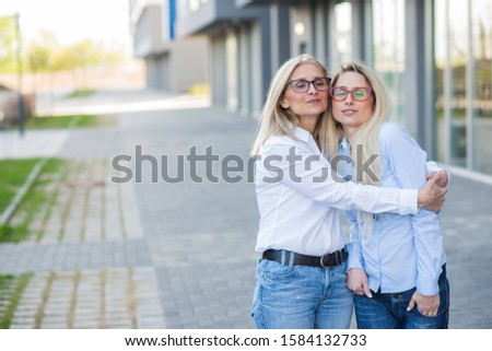 Similar – Image, Stock Photo Twin sisters look around in an alleyway