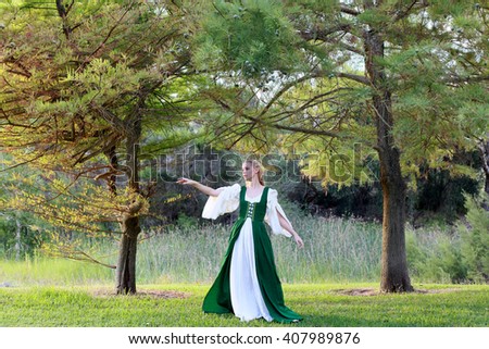 A  beautiful blonde lady wearing a long green medieval gown, wandering in a forest.