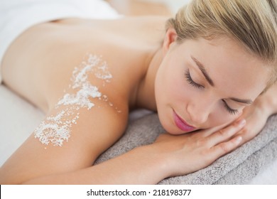 Beautiful blonde lying on massage table at the health spa