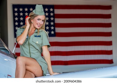 A Beautiful Blonde Model Poses With A Vintage WWII Aircraft