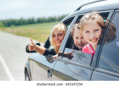 Beautiful Blonde Mom While Driving A Car With Her Children