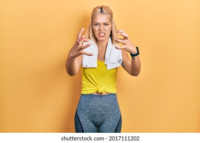 Beautiful Blonde Sports Woman Wearing Workout Outfit Shouting Frustrated With Rage, Hands Trying To Strangle, Yelling Mad 