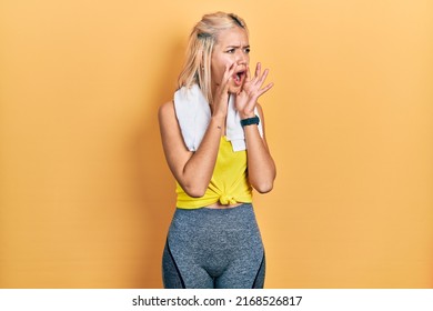 Beautiful Blonde Sports Woman Wearing Workout Outfit Shouting Angry Out Loud With Hands Over Mouth 