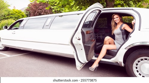 Beautiful Blonde Stepping Out Of Limousine On A Sunny Day