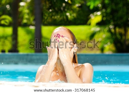Beautiful blonde swimming in the pool