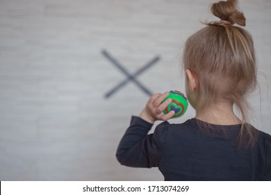 Beautiful Blonde Toddler Standing Throwing Ball To The Wall. Activity For Kids At Home.