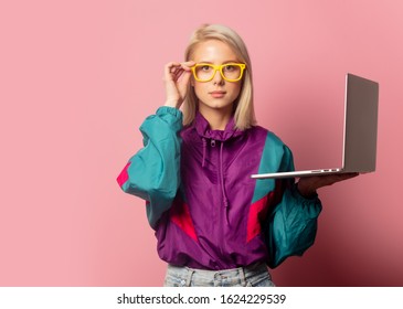 Beautiful Blonde Woman In 90s Clothes With Laptop Computer On Pink Background