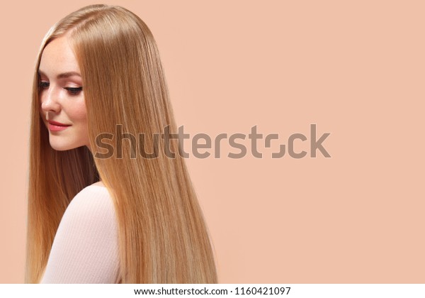 Beautiful Blonde Woman\
Beauty Model Girl with perfect makeup and long straight hair on\
light copyspace