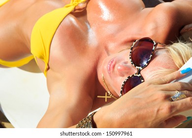 Beautiful blonde woman in bikini on the beach