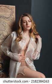 Beautiful Blonde Woman In A Corset And Transparent Shirt, Fashion Studio Portrait