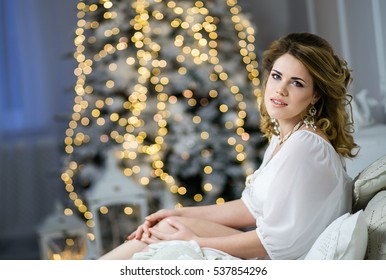 Beautiful Blonde Woman In A Dressing Gown On A Gentle Background Christmas Tree, New Year's Morning