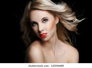 Beautiful Blonde Woman With Flying Hair On A Black Background