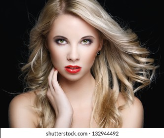 Beautiful Blonde Woman With Flying Hair On A Black Background