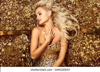 Beautiful blonde woman in golden flowers garden