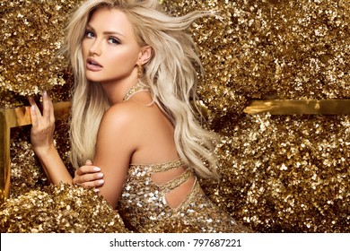 Beautiful blonde woman in golden flowers garden