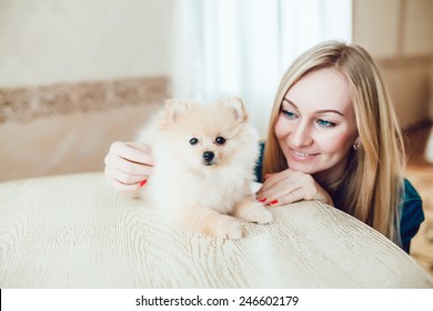 Beautiful Blonde Woman with Her Dog in a Beautiful Interior - Shutterstock ID 246602179