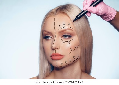 Beautiful blonde woman with markings for plastic surgery on her face - Powered by Shutterstock