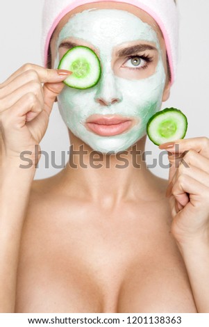 Beautiful blonde woman with moisturized face mask. Beauty spa. Skincare concept. Woman with facial mask.