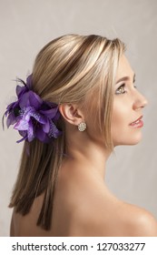 Beautiful Blonde Woman With Purple Flower Hair Clip