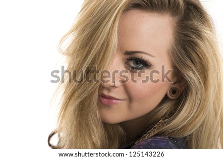 Beautiful blonde woman smiling with hair covering one eye