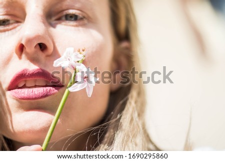 Beautiful blonde woman with spring flower