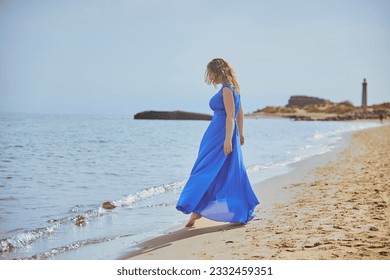 Beautiful blonde woman walking near the sea in Grenen Denmark