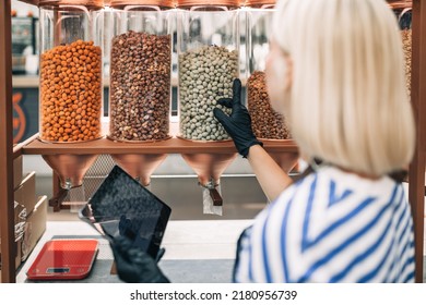 Beautiful Blonde Woman Working At Health Food Store. Plastic Free Shop. Healthy Food Concept. 