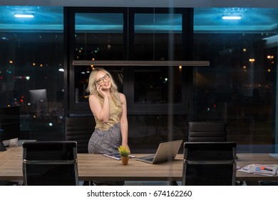 Beautiful Blonde Woman Working In Modern Office Overtime. Woman Working Night Shift.