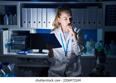 Beautiful Blonde Woman Working At Scientist Laboratory Late At Night Feeling Unwell And Coughing As Symptom For Cold Or Bronchitis. Health Care Concept. 